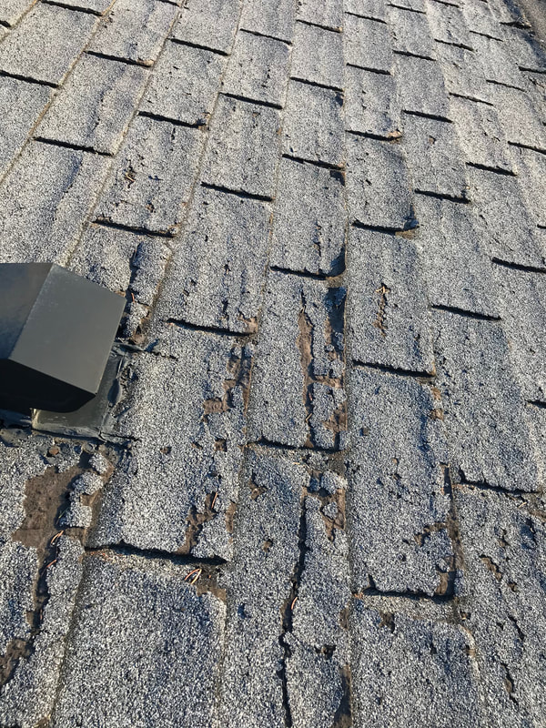 Delaminated old shingles that are in need of immediate replacement observed during a home inspection by Dairyland Home Inspection in racine, Wisconsin. 