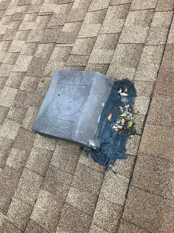 Roof vent flashing covered with roofing sealant improperly and observed during a home inspection by Dairyland Home Inspection.